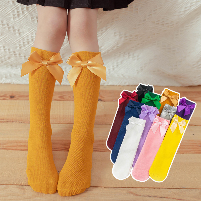 ถุงเท้ายาวเด็กผู้หญิงสีแดง(ไวน์) สีขาว สีเขียวเข้ม สีชมพู สีดำ สีม่วงเข้ม สีเหลือง ติดโบว์น่ารัก สดใส สไตล์แฟชั่นเกาหลี ขนาดแบบฟรีไซส์ ยาว 28 cm.