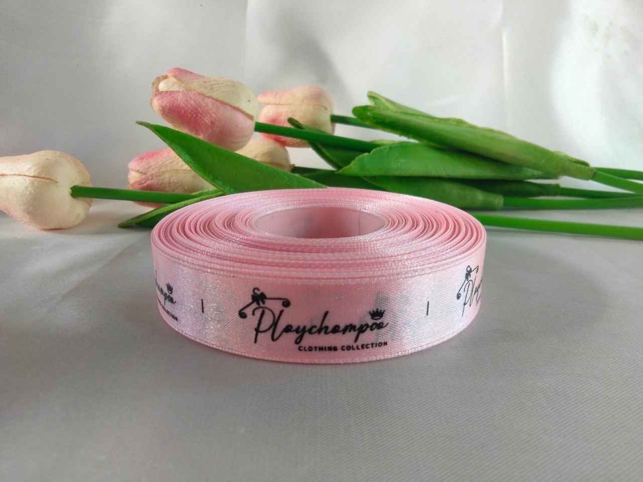 ป้ายคอเสื้อ เนื้อริบบิ้นซาติน 2 ซม. ริบบิ้นสีชมพู64 พิมพ์ดำ 1 ม้วน