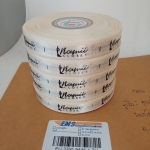 ป้ายคอเสื้อ เนื้อริบบิ้นซาติน 1.3 ซม. ริบบิ้นสีครีม S-2 พิมพ์ดำ 5 ม้วน